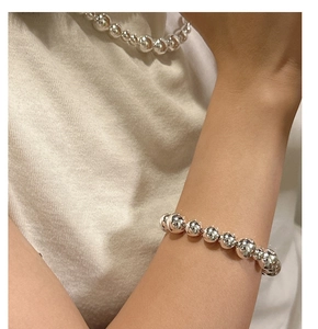 Polished S925 sterling silver beaded bracelet and necklace set shown on a model