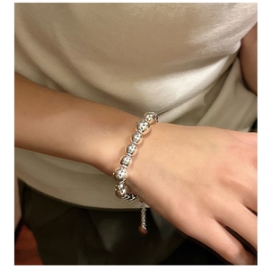 Detailed close-up of S925 sterling silver beaded bracelet worn on a woman's wrist