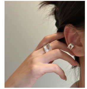 Detailed view of textured S925 sterling silver cuff earring and ring with hollow design