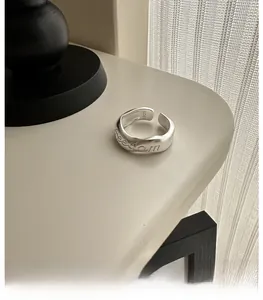 Close-up of S925 sterling silver freedom ring with wave texture and interior hallmark