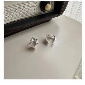 Detailed view of wide S925 sterling silver ear clips with unique hammered texture and cutouts