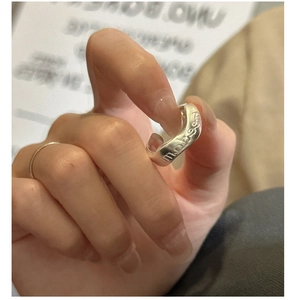 Detail of 925 sterling silver ring with nobody engraving and wavy textured design