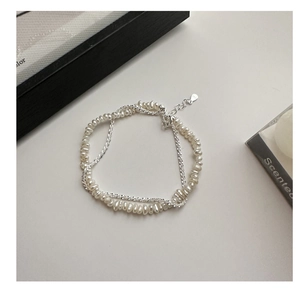 Detail of S925 sterling silver double-layer bracelet with baroque pearls and sparkling chain