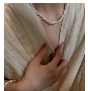 Close-up of S925 silver woven pearl necklace and bracelet set with elegant luster