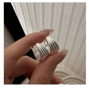 Close-up of S925 sterling silver multi-layer hoop earrings with polished metal finish