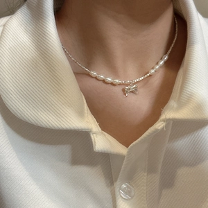 Elegant S925 silver bow pearl necklace worn on model featuring a minimalist sweet style