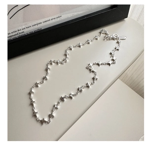 Close-up of S925 sterling silver four-pointed star necklace with lobster clasp