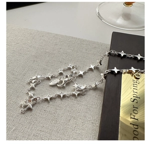 Macro shot of S925 sterling silver four-pointed star necklace with lobster clasp