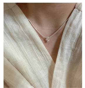 Close-up of a 925 sterling silver snake chain necklace with minimal double bead pendants