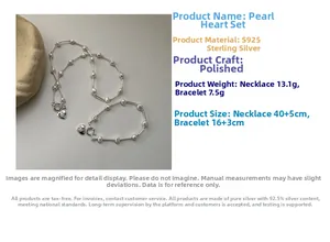 Detailed view of S925 sterling silver heart charms on a natural pearl necklace and bracelet