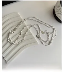 Close-up of S925 sterling silver layered necklace with round beads and snake bone chain