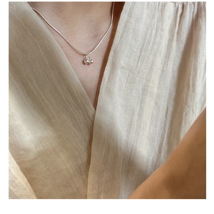 Close-up of minimalist S925 sterling silver cherry pendant necklace on a neck
