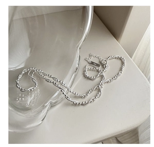Detail of S925 sterling silver double layer snake chain necklace and bead strand close-up