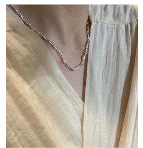 Detail shot of a S925 sterling silver layered snake chain necklace worn on the neck