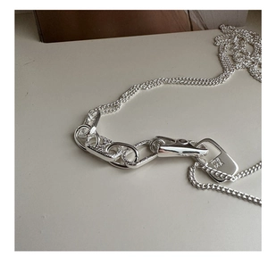 Close-up of 925 sterling silver chain necklace with square ma MA engraved pendant