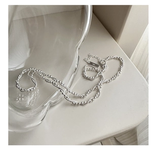 Detailed close-up of S925 sterling silver double-layer snake chain with small round beads