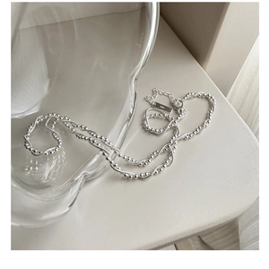 Detailed macro view of S925 sterling silver lobster clasp and adjustable extension chain