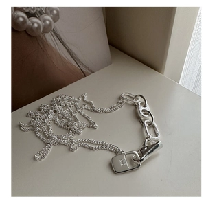 Detail of 925 sterling silver necklace with engraved rectangular locket pendant