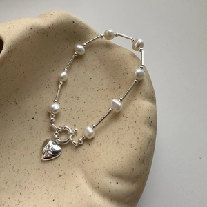 Elegant S925 silver heart and pearl bracelet with star engraving on ceramic bowl