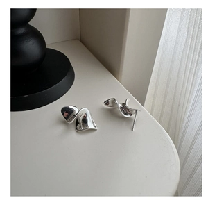 Detail of S925 sterling silver earrings with irregular wave design and metallic luster