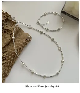 Detail of S925 silver necklace and bracelet set with white pearls and textured silver beads