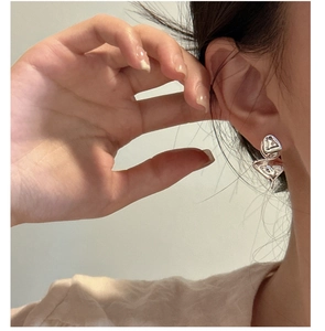 Close-up of irregular silver S925 sterling silver earrings with organic lava design
