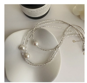Detail of S925 silver layered necklace with Edison pearls in a French vintage style
