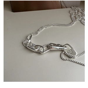 Detail of 925 sterling silver chain necklace with rectangle ma MA charm and clasp