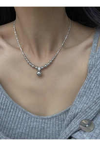 S925 sterling silver beaded necklace with large grey pearl pendant worn on collarbone