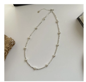 Detail of S925 silver beaded necklace with round pearls and heart tag lobster clasp
