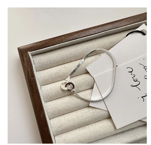 Detail of silver snake chain bracelet with interlocking double rings and Korea engraving