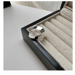 Detailed view of S925 silver wide twisted ribbon ring with high-polished mirror finish