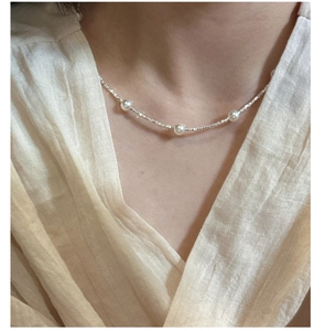 Detailed view of an S925 sterling silver necklace featuring delicate pearls and silver beads