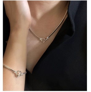 Detail shot of 925 sterling silver double-ring snake chain necklace on model