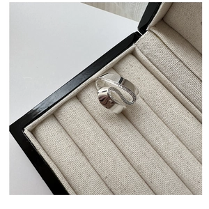 Macro detail of S925 sterling silver S-shaped ring with polished mirror surface in jewelry box