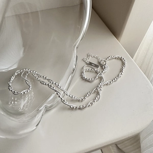 Double-layered S925 sterling silver snake chain necklace with beads on white background