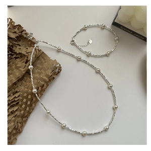 Detail of S925 sterling silver pearl necklace and bracelet set with heart charms