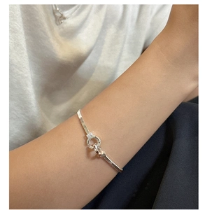 Close-up of S925 sterling silver snake chain necklace featuring engraved Korea lock charm