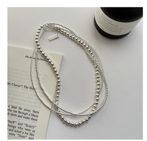 Detailed close-up of S925 sterling silver layered bead necklace with adjustable chain