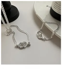 Macro detail of S925 silver Cuban link chain and double rings with Korea engraving