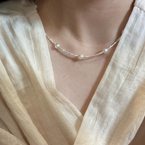 Elegant S925 sterling silver chain necklace with four white pearls on a female model