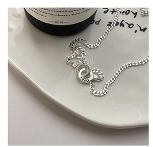 Detail of S925 silver double interlocking loop buckle on a chunky Cuban chain link
