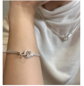 Close-up of S925 sterling silver interlocking horseshoe buckle on Cuban chain bracelet