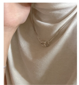 Close-up of S925 sterling silver interlocking double ring necklace on model