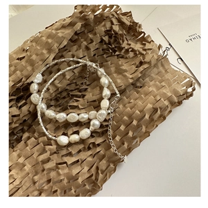Detail of S925 silver beaded bracelet with irregular baroque pearls and lobster clasp closure