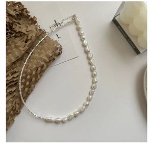 Detail of baroque pearl and S925 silver bead necklace with adjustable lobster clasp
