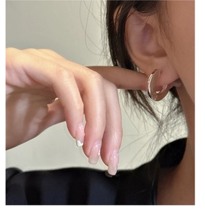 Close-up of minimalist S925 sterling silver chunky hoop earring on model ear