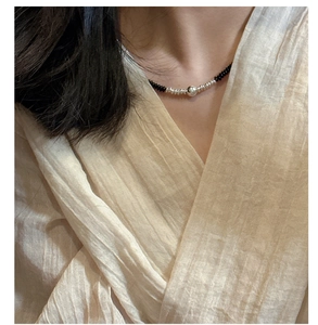 Close-up of 925 sterling silver black onyx bead necklace on a model's neck