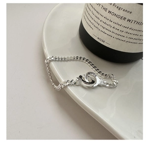 Detailed close-up of S925 sterling silver curb chain with double-ring clasp engraving