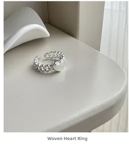Close-up of S925 silver braided ring with heart shape and Only Love engraving